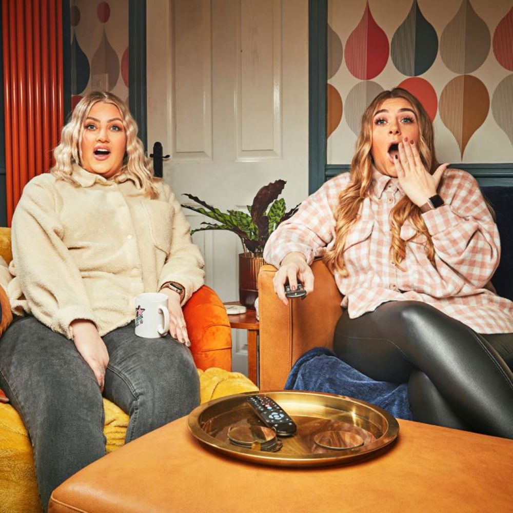 Sisters Elli and Izzi from Channel 4's Gogglebox are mouth-open, shocked at  something they are watching television.